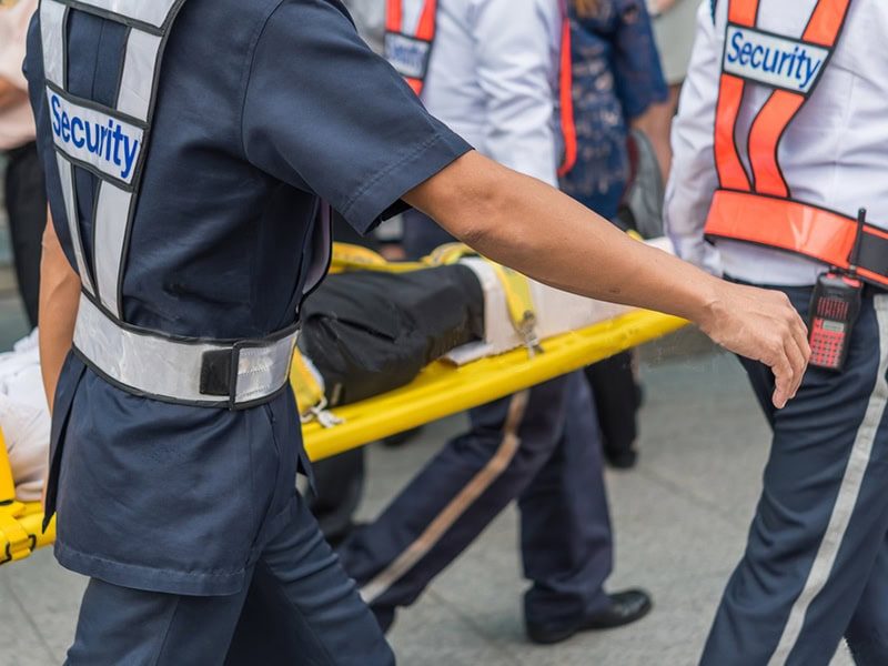 Security team carrying patient on stretcher