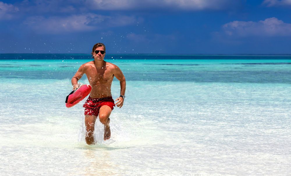 Lifeguard Walking with Rescue Buoy