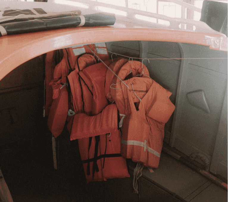 Orange Life Jackets Hanging Inside Boat Cabin